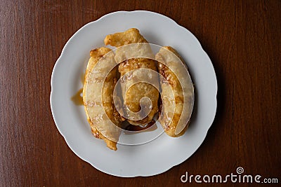 Top down view of pisang goreng (fried banana) on a white plate Stock Photo