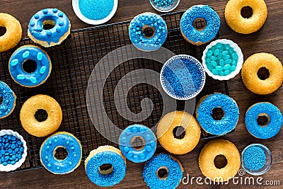 Top down view of plain a blue chocolate dipped donuts decorated with sprinkles. Stock Photo