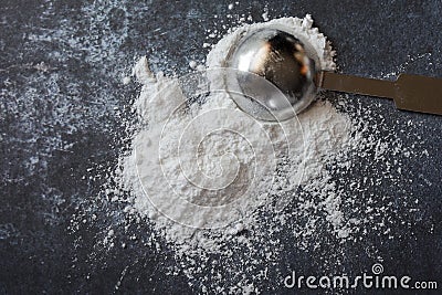 Baking Powder Spilled from a Teaspoon Stock Photo