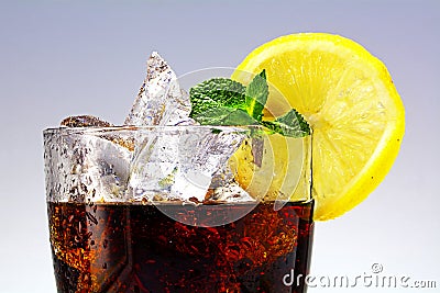 Top of a glass of cola or coke with ice cubes, lemon slice and p Stock Photo