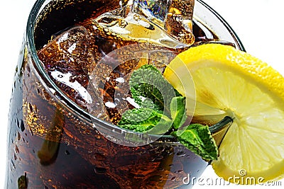 Top of a glass of cola or coke with ice cubes, lemon slice and peppermint garnish Stock Photo