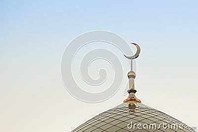 The top of the golden minaret with the symbol of Islam is the growing moon of the golden crescent moon. Right in the frame. Stock Photo