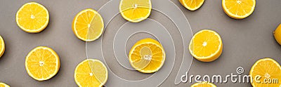 top of halves of fresh and ripe lemons on grey, banner. Stock Photo