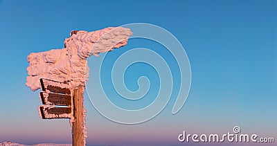 Tourist signpost mountain top Lusen covered by large ice. View of the snowy mountain peaks, view from Lusen in Bavaria in the Stock Photo