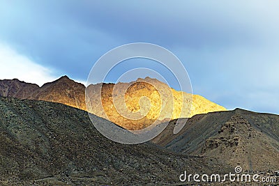 Top of the mountain lit by the setting sun Stock Photo