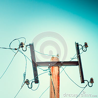 Top old electrical pillar on a background of the blue sky Stock Photo