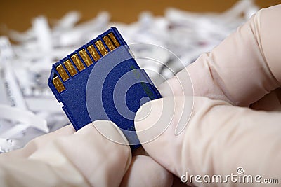 Top secret information on memory card among shredder paper, thief information concept Stock Photo