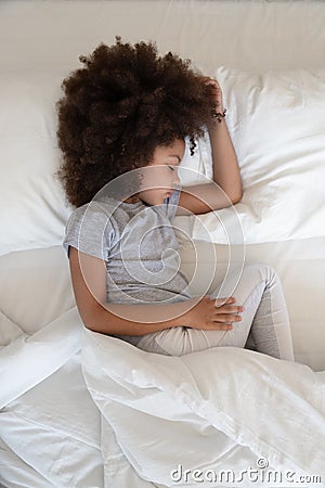 Top view above vertical image uncovered little kid sleeping. Stock Photo