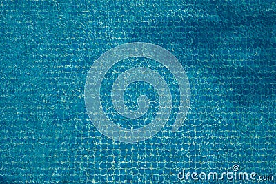 Top view of abstract blurred texture of blue wave water with mosaic tiles in swimming pool. Stock Photo