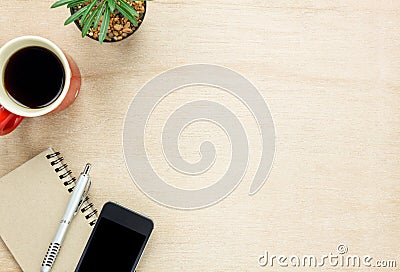 Top view accessories office desk the mobile phone,note paper,pen,coffee on wooden office desk background. Stock Photo