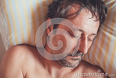 Top view of adult caucasian male sleeping in bed Stock Photo