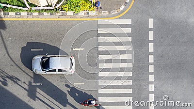 Top view aerial photo of a driving motorcycle and bus on asphalt track and pedestrian crosswalk in traffic road with light and Editorial Stock Photo