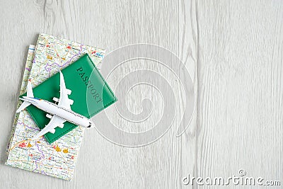 Top view airplane model, map and passport document on wooden background. Travel planning, airplane insurance concept. Travel Stock Photo