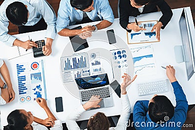 Analyst team utilizing BI Fintech to analyze financial data at table. Prudent Stock Photo
