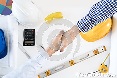 Top view Architect and engineer shaking hands, finishing up a me Stock Photo