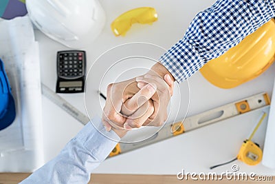 Top view Architect and engineer shaking hands, finishing up a me Stock Photo