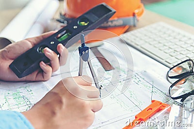 Top View Architect working on blueprint. Architects workplace. Engineer tools and safety control, blueprints, ruler, orange helm Stock Photo