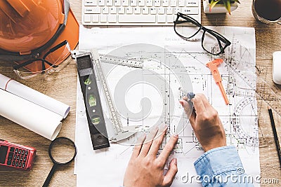 Top View Architect working on blueprint. Architects workplace. Engineer tools and safety control, Stock Photo