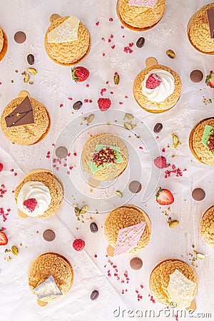 Assortment of French choux cream puffs with fruit and chocolate Stock Photo