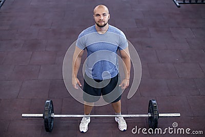 Top view of a athletic man works out at the gym with a barbell Stock Photo