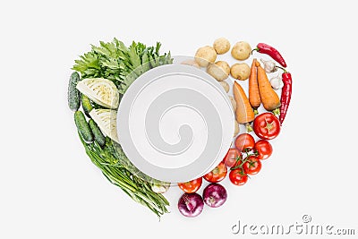 top view of autumn harvest arranged in heat shape with empty plate in middle Stock Photo