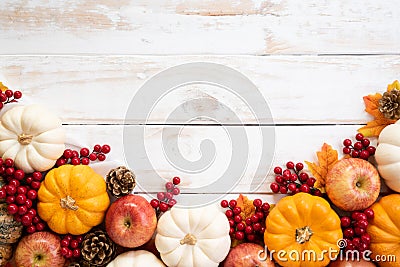 Autumn maple leaves with Pumpkin and red berries on old wooden background. Thanksgiving day concept Stock Photo