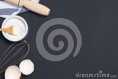 Top view of backing background with flour, rolling pin, eggshells, utility whisk Stock Photo