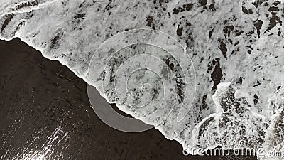 Top view of balis beach with a wave and black sand Stock Photo
