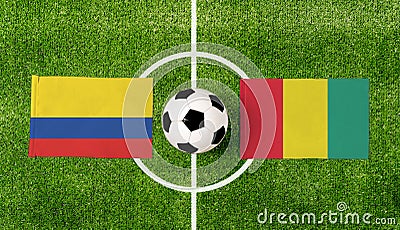 Top view ball with Colombia vs. Guinea flags match on green football field Stock Photo