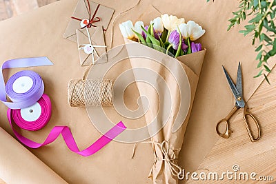 top view of beautiful bouquet of tulips, scissors, ribbons and envelopes with rope Stock Photo