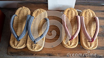Top view of beautiful two pairs weave shoes on wooden shelf for background Stock Photo