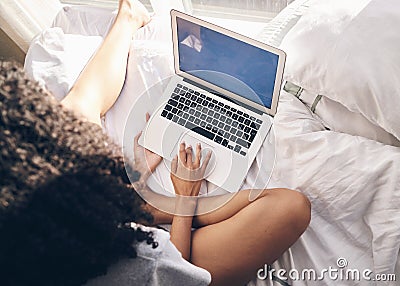 Top view, bed and woman browsing on a laptop for social media or the internet in the morning. Technology, bedroom and Editorial Stock Photo