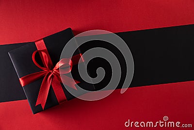 Top view of black christmas boxes with red ribbon on black background with copy space for text. black Friday and Boxing Day Stock Photo