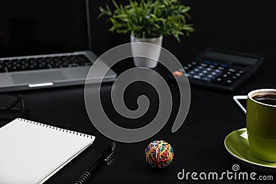 Top view, black desk with computer graph, magnifier and calculator Stock Photo