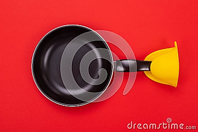 Frying pan with oven MITT isolated on red background Stock Photo