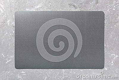 Top view of black place mat for a dish. Cement background with empty space for your design Stock Photo