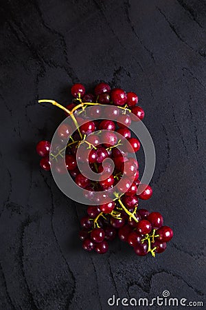 Top view of black table with red grape cluster Stock Photo
