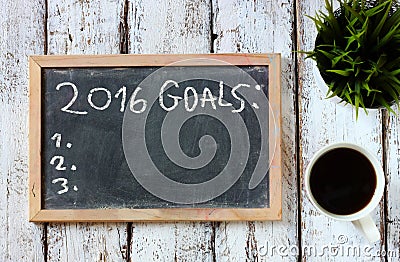 Top view of blackboard with the phrase 2016 goals over wooden board with coffee Stock Photo