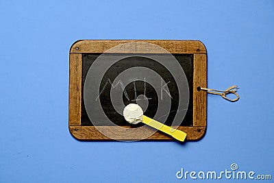 top view of blackboard and scoop of baby powder milk with the word milk written on the blackboard. flat lay Stock Photo