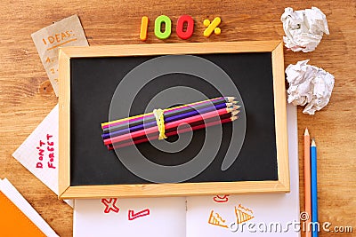 Top view of blackboard , stack of pencils and crumpled paper. Stock Photo