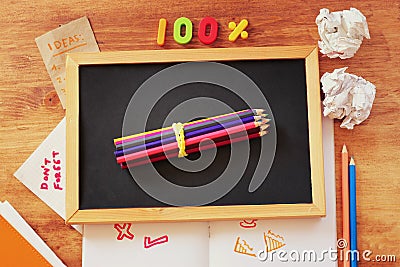 Top view of blackboard , stack of pencils and crumpled paper Stock Photo