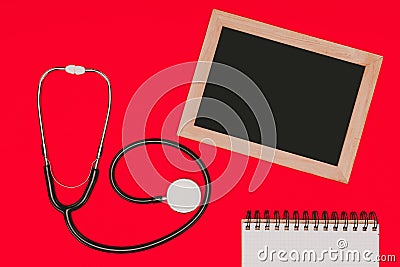 top view of blank chalkboard, notebook and stethoscope Stock Photo