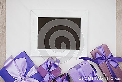 top view of blank chalkboard with various gift boxes Stock Photo