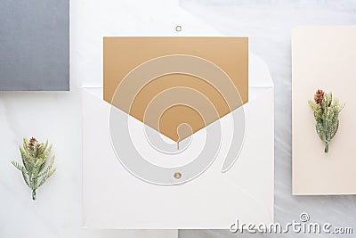 Top view of blank gold card in white envelop with pine leaf on t Stock Photo