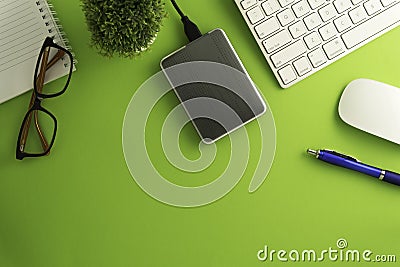 Top view of blank paper page on green background office desk and different objects. Minimal flat lay style Editorial Stock Photo