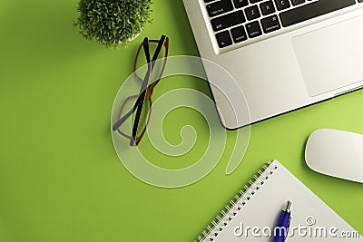 Top view of blank paper page on green background office desk and different objects. Editorial Stock Photo