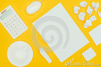 top view of blank sheet of paper, crumpled papers, notes, calculator and computer mouse Stock Photo
