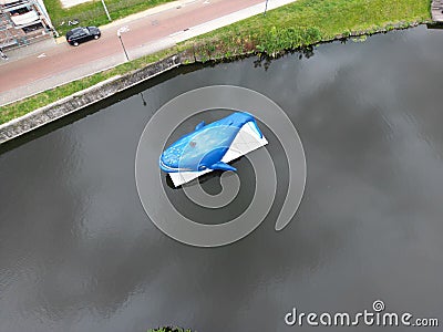 Top view of a blue whale statue on the Dender River in Dendermonde, Belgium Editorial Stock Photo