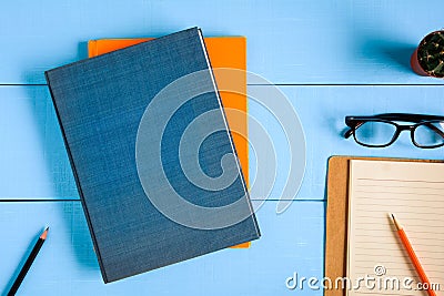 top view book mockup and pencil note on blue wood table Stock Photo