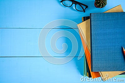 top view book mockup and pencil note on blue wood table Stock Photo